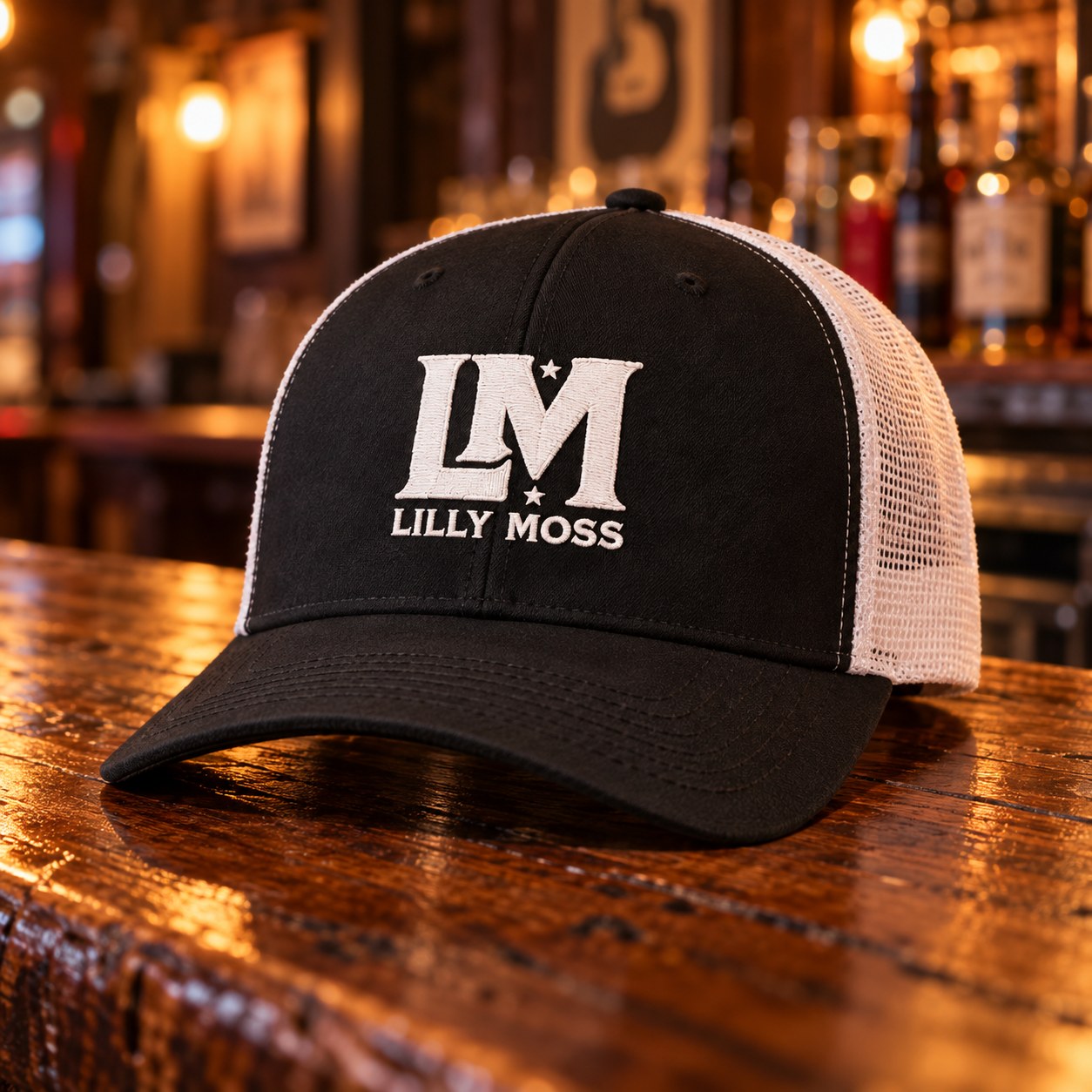 Lilly Moss black and white trucker hat sitting on a bar top